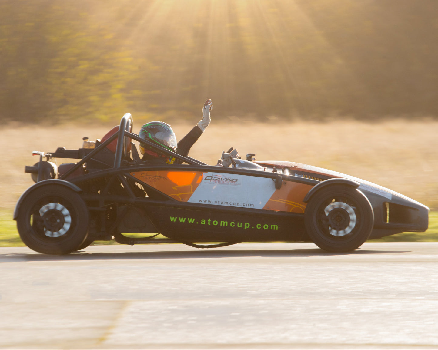 Formula student car on a track with a sunlit background