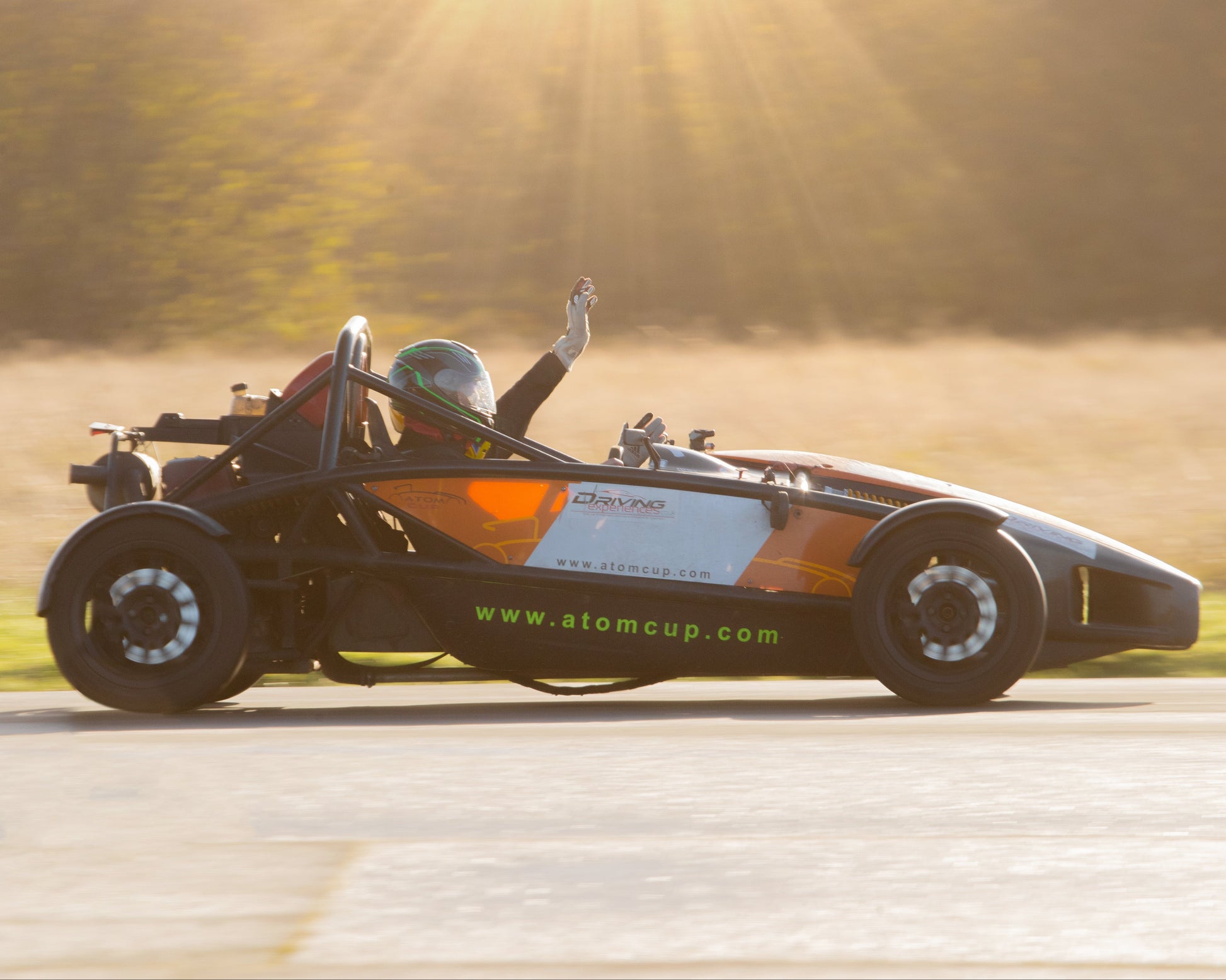 Formula student car on a track with a sunlit background