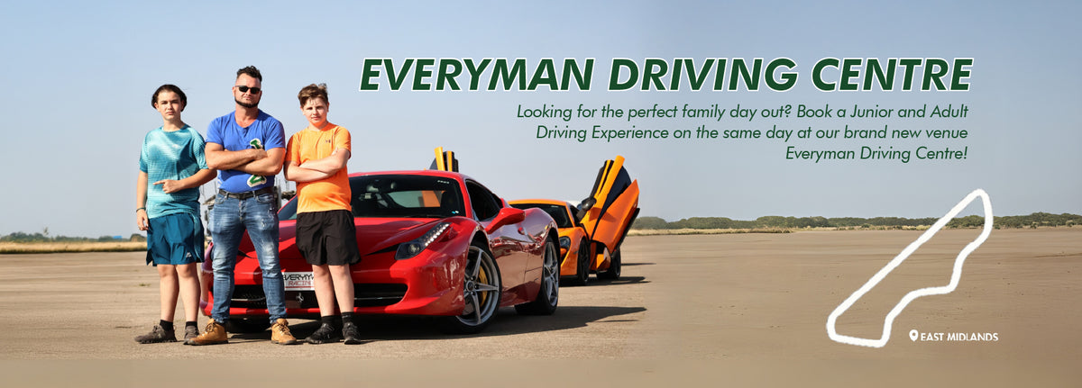 Promotional banner for Everyman Driving Centre with people standing next to a red car and an orange car on a track.